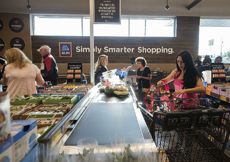 Customers check out at a new Aldi grocery store in Tyler, Texas, last week. The U.S. Labor Department said the rise in consumer prices, a gauge of inflation, slowed in August. 