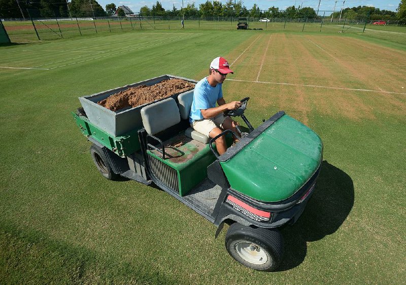 Tyler Carr, a University of Arkansas graduate student from White Hall, works to level one of a pair of grass tennis courts at the uni- versity’s turf science facility on the university farm in Fayetteville. Carr is working with Doug Karcher, a soil and turf grass scientist, to study the feasibility of maintaining grass tennis courts in Arkansas. 