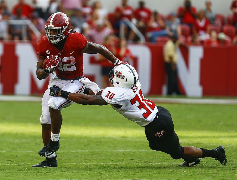 Arkansas State defensive back Derrick Bean (30) tries to stop Alabama running back Najee Harris during the second half Saturday in Tuscaloosa, Ala. Bean has eight tackles through ASU’s first two games, tying for fourth-most on the team and the most by a freshman.