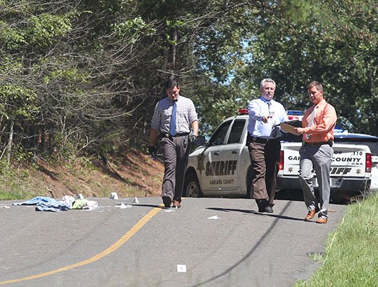 The Sentinel-Record/Richard Rasmussen CRIME SCENE: From left, Garland County sheriff's Investigators Brandon Huckaba and Randy Rowe, and Cpl. Kenny Ford, investigate the scene where a juvenile female was reportedly found shot "multiple times" on Thursday, Sept. 13.