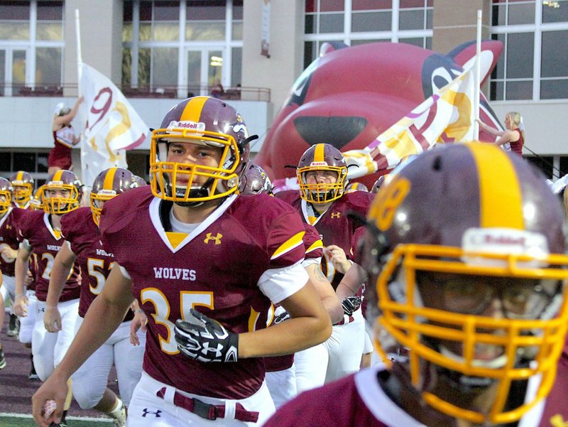 The Sentinel-Record/File photo HEADING OUT: Lake Hamilton sophomore running back Angel Diaz (35) exits the team's tunnel before the Wolves defeated Malvern, 56-10, a week ago in Pearcy.