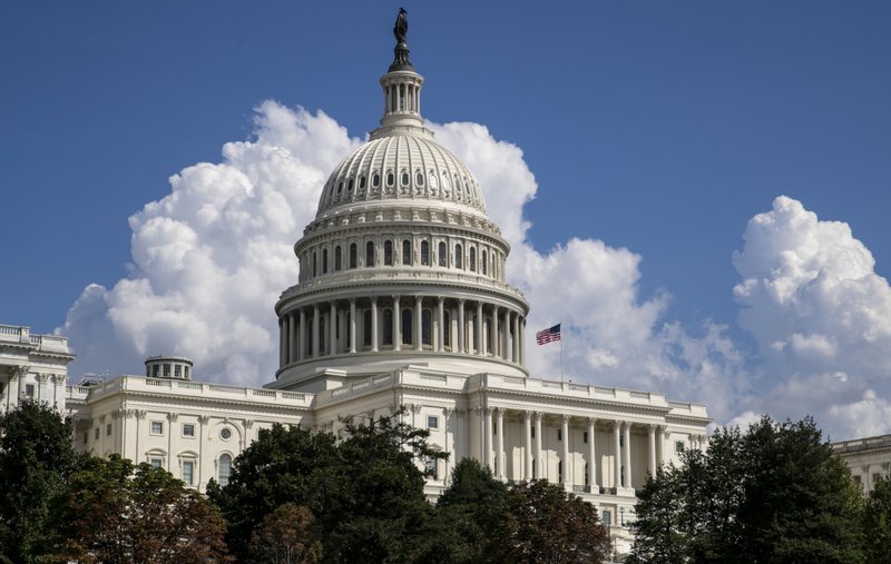 FILE- In this Sept. 3, 2018, file photo an American flag flies on the U.S. Capitol in Washington. On Thursday, Sept. 13, the Treasury Department releases federal budget data for August. (AP Photo/J. Scott Applewhite, File)