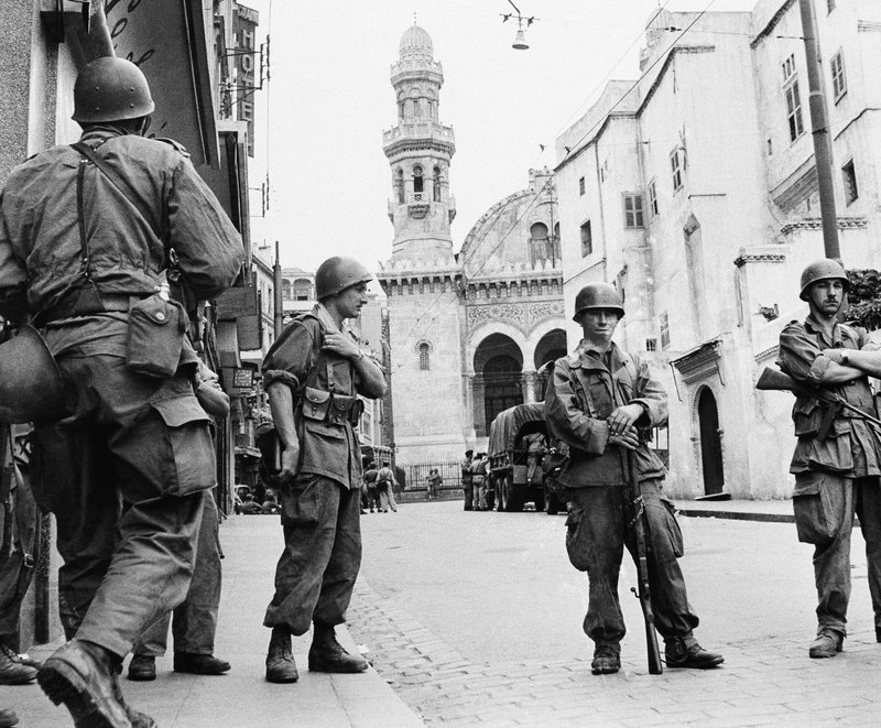 FILE - In this May 27, 1956 file photo, French troops seal off Algiers' notorious casbah, 400-year-old teeming Arab quarter. French President Emmanuel Macron has formally recognized that the French state was responsible for the death of a dissident mathematician in Algeria in 1957, admitting for the first time the French military's &quot;system&quot; of torture during Algeria's independence war. (AP Photo)