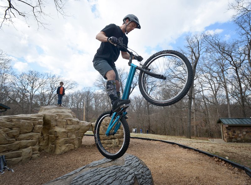 Ryan Bratton of Bentonville practices his skills on Sunday Feb. 28, 2016 during a NWA Bike Trials group ride at Park Springs Park in Bentonville. Bratton heads the NWA Bike Trials group and recently gained sponsorship from Mojo Cycling in Bentonville.