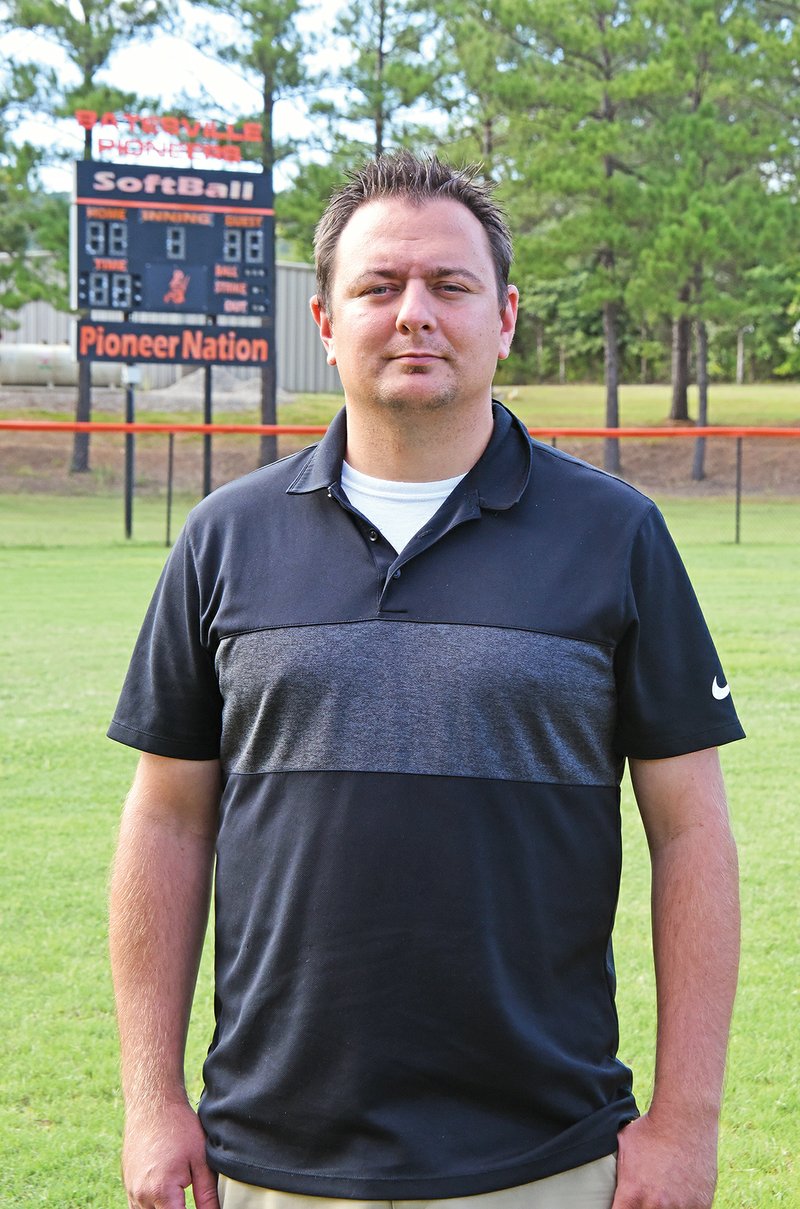 Scott Hoffman, the softball coach at Batesville High School, stands on the field where he started volunteering to coach girls fast-pitch softball 22 years ago, when he was a resident of the Arkansas Sheriffs’ Youth Ranch. “I knew at 15 years old I wanted to be a coach, and I wanted to help young people, and I wanted to compete in athletics,” Hoffman said. He credits his Batesville High School football coaches and his house parents at the Youth Ranch with helping turn his life around.