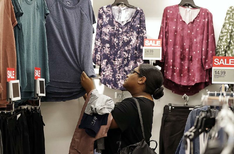 A shopper checks out a clothing rack at a Kohl’s store in Concord, N.C., in August. Sales of clothes dropped 1.7 percent in August, the steepest decline in 18 months. 