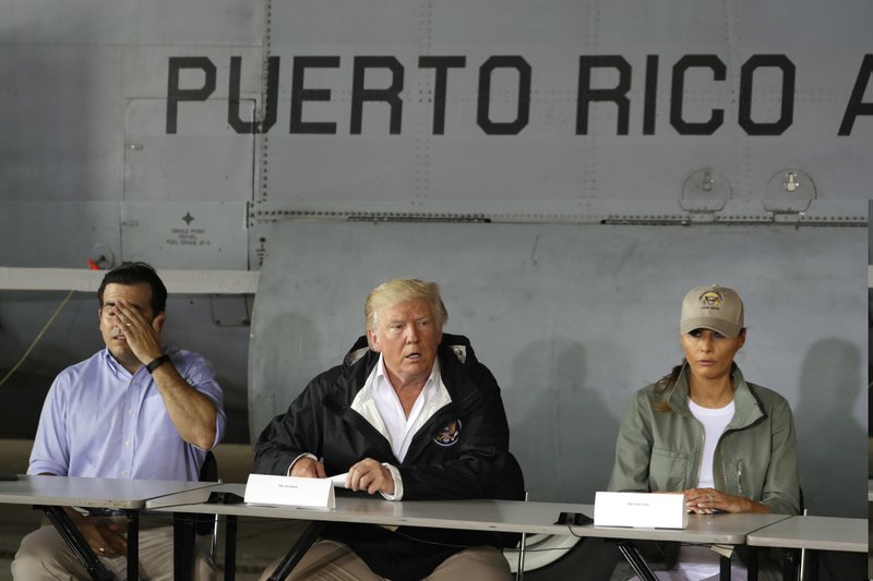 FILE - In this Oct. 3, 2017, file photo, President Donald Trump talks about recovery efforts after he and first lady Melania Trump arrived at Luis Muniz Air National Guard Base to survey hurricane damage in San Juan, Puerto Rico, as Puerto Rico Gov. Ricardo Rossell&#xf3;, left, listens. Trump loves to cite stats, numbers to bolster his political standing. He just doesn&#x2019;t seem to care much about whether they&#x2019;re true. (AP Photo/Evan Vucci, File)