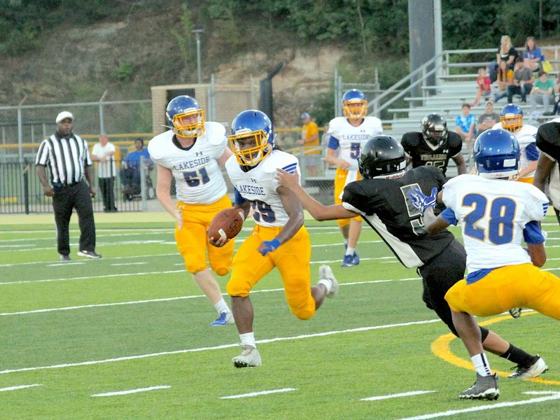 The Sentinel-Record/James Leigh CROSS THE FIELD: Lakeside's Chance Cross avoids a tackle by Hot Springs' Steven Robinson Thursday in the first quarter of the junior Rams' 39-14 win at Tommy J. Holt Field at Joe Reese Stadium.