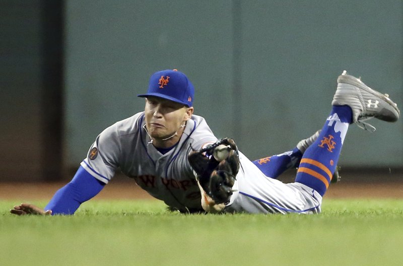 New York Mets right fielder Brandon Nimmo makes a diving catch of a fly ball by Boston Red Sox's Mookie Betts in the fifth inning of a baseball game at Fenway Park, Friday, Sept. 14, 2018, in Boston. (AP Photo/Elise Amendola)