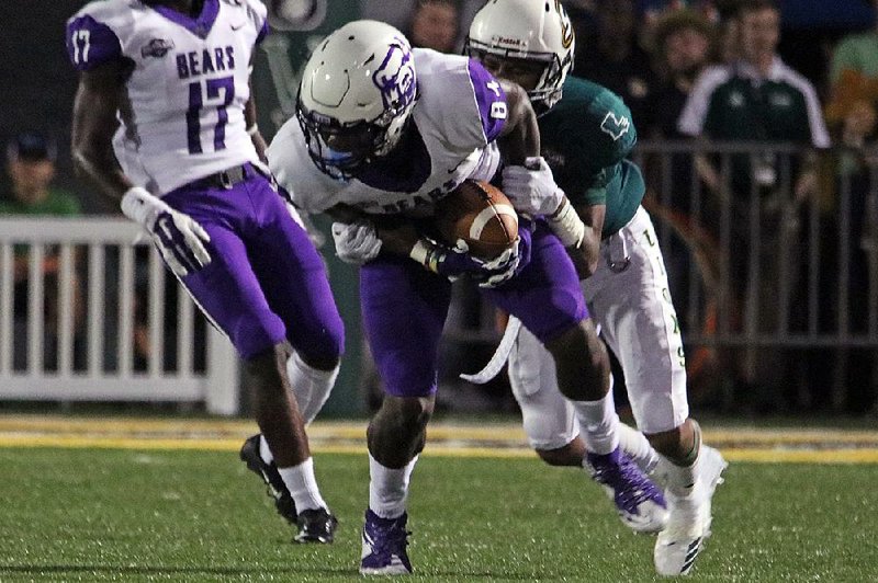 Central Arkansas receiver Brandon Myers  (front)  tries  to escape a tackle by a Southeastern Louisiana defender Saturday during the Bears’ 33-25 victory over the Lions in Hammond, La. 
