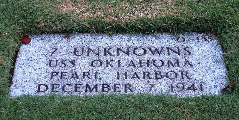 A marker sits in the National Memorial Cemetery of the Pacific in Honolulu for seven unknown people who died when the USS Oklahoma sank on Dec. 7, 1941. Researchers are still working to identify remains of hundreds of Americans who were aboard the ship.