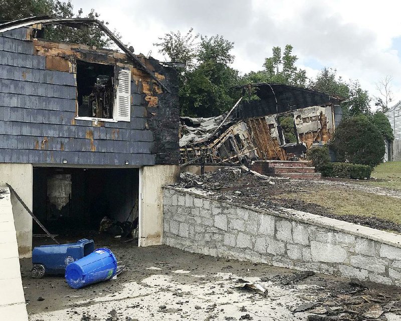 A burned house owned by police officer Ivan Soto is seen Friday in Lawrence, Mass. 