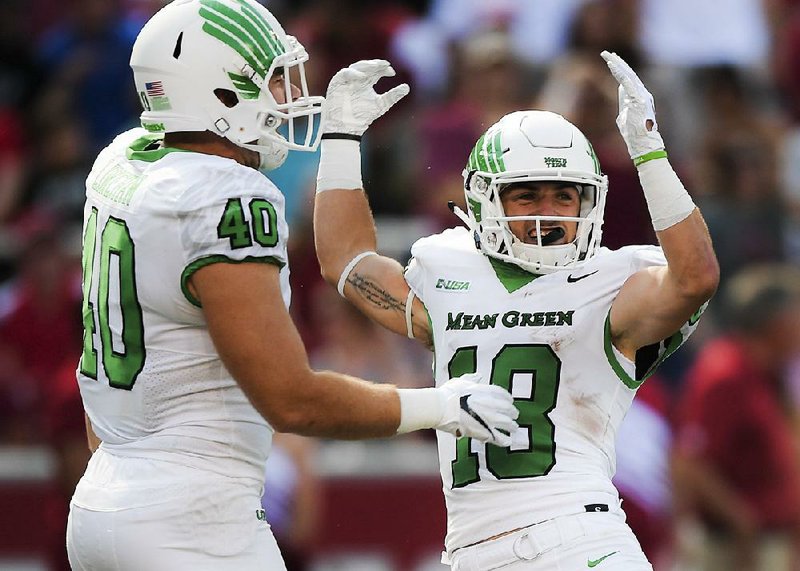 North Texas Mean Green wide receiver Keegan Brewer (18) reacts after scoring  from running the ball back from a punt after signaling for a fair catch during the first quarter of a football game, Saturyday, September 15, 2018 at Donald W. Reynolds Razorback Stadium in Fayetteville.

