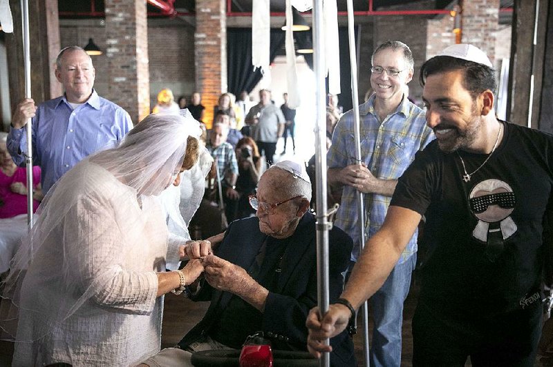 Judy Goldman, 76, and Mannie Corman, 100, exchange rings during their wedding at The Liberty Warehouse in New York on Sept. 3. 
