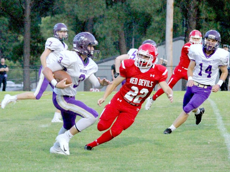The Sentinel-Record/Jami Smith RIGHT OF WAY: Centerpoint running back Landon Way (3) works to avoid Mountain Pine defender Brock Alexander (22) Friday during the Knights' 48-18 road win at Stanley May Field.