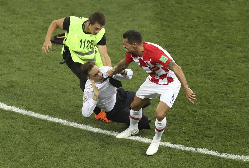  In this Sunday, July 15, 2018 file photo, Croatia's Dejan Lovren and a steward grab Pyotr Verzilov, who invaded the pitch during the France and Croatia 2018 World Cup final match in the Luzhniki Stadium in Moscow, Russia. Russian news reports say Verzilov, a member of Russian punk protest group Pussy Riot, has been hospitalized in grave condition for what could be a possible poisoning. (AP Photo/Thanassis Stavrakis, File)