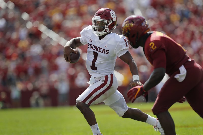 Oklahoma quarterback Kyler Murray, center, runs the ball as he is chased to the sidelines by Iowa State linebacker Willie Harvey, right, during the second half of an NCAA college football game, Saturday, Sept. 15, 2018, in Ames, Iowa. Oklahoma won 37-27. (AP Photo/Matthew Putney)