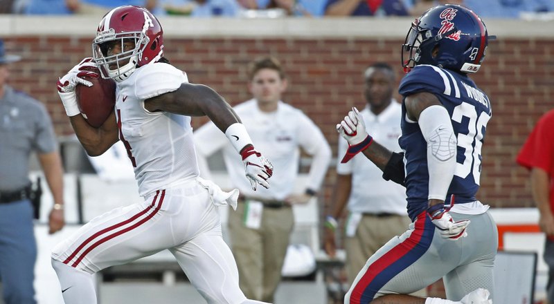Alabama wide receiver Jerry Jeudy (4) runs past Mississippi defensive back Zedrick Woods (36) on his way to a 79-yard touchdown pass reception during the first half of their NCAA college football game on Saturday, Sept. 15, 2018, in Oxford, Miss. (AP Photo/Rogelio V. Solis)
