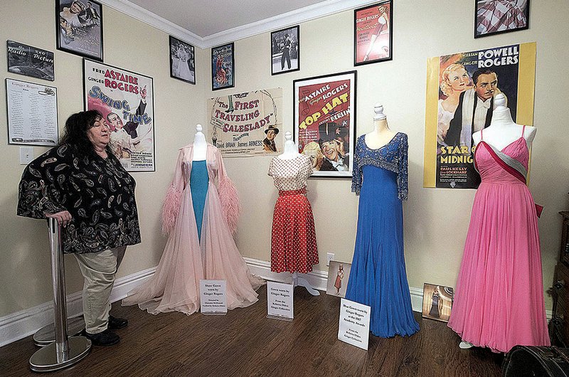 Marge Padgitt admires her collection of dresses once worn by Ginger Rogers. Padgitt bought Rogers’ birthplace in Independence, Mo., and now operates it as The Ginger Rogers Museum. 