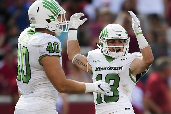 North Texas Mean Green wide receiver Keegan Brewer (18) reacts after scoring from running the ball back from a punt after signaling for a fair catch during the first quarter of a football game, Saturday, September 15, 2018 at Donald W. Reynolds Razorback Stadium in Fayetteville.