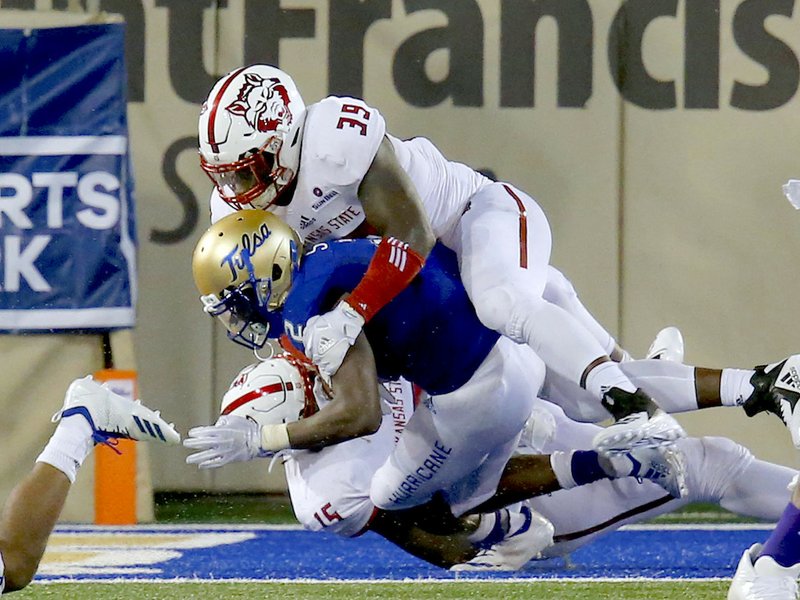 TU's Keylon Stokes is tackled for a safety by Arkansas State's Kevin Thurman and Dajon Emory at H.A. Chapman Stadium in Tulsa, OK, Sept. 15, 2018. STEPHEN PINGRY/Tulsa World