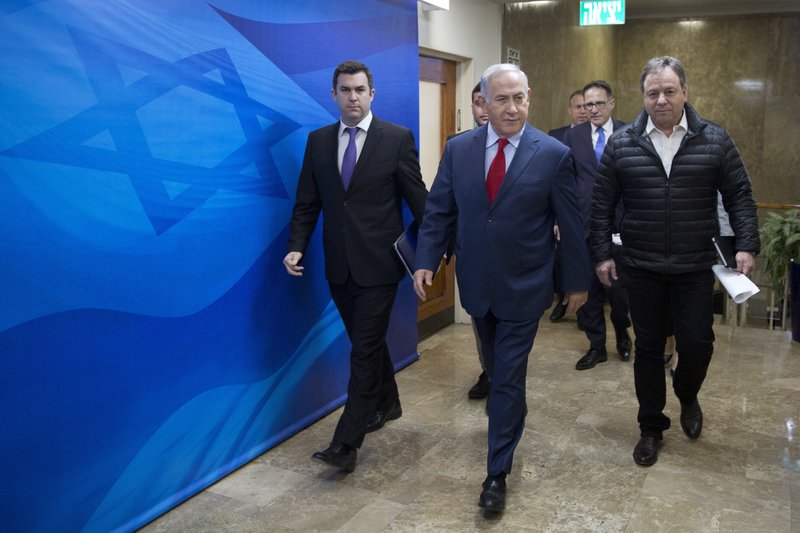 File - In this Sunday, March 11, 2018 file photo Israeli Prime Minister Benjamin Netanyahu, escorted by his spokesman David Keyes, left, arrives for the weekly cabinet meeting at his office in Jerusalem. An Israeli opposition lawmaker on Sunday called on Netanyahu to dismiss his ambassador to the United States Ron Dermer for failing to report sexual assault allegations against a top Netanyahu aide,(AP Photo/Oded Balilty, File)