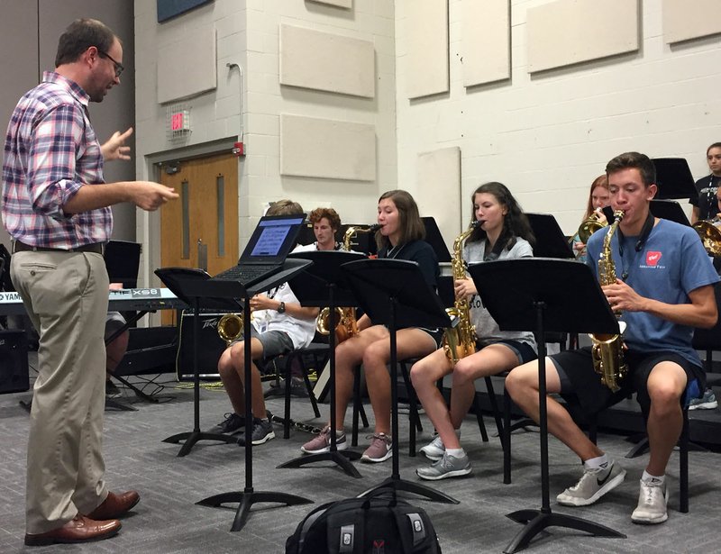 NWA Democrat-Gazette/DAVID PEROZEK Philip Shewmaker, the jazz band director at Bentonville High School, works Thursday with students. The Bentonville High School jazz band is re-emerging after an extended layoff following the death of the band's director, Zach Roddy, five years ago.