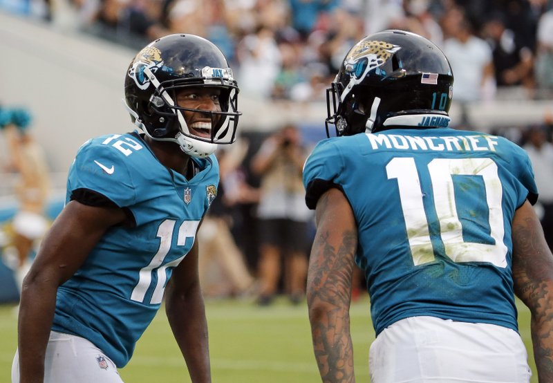 Jacksonville Jaguars wide receiver Dede Westbrook (12) celebrates his 61-yard touchdown against the New England Patriots with teammate wide receiver Donte Moncrief (10) during the second half of an NFL football game, Sunday, Sept. 16, 2018, in Jacksonville, Fla. (AP Photo/Stephen B. Morton)