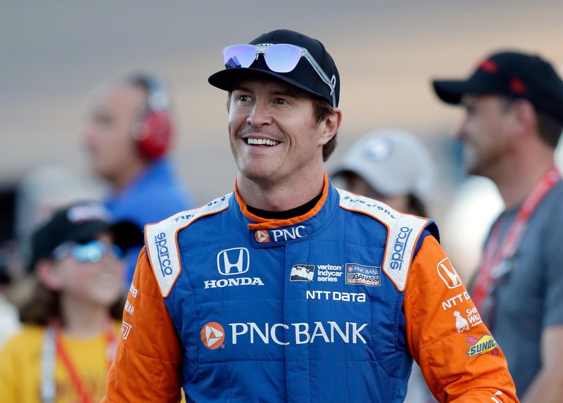 FILE - In this, April 7, 2018, file photo, driver Scott Dixon smiles before the IndyCar auto race at Phoenix International Raceway in Avondale, Ariz. Dixon has blazed his way through the record books to cement himself as the greatest IndyCar driver of his generation. One more championship will give him five, second in the open wheel record books only to A.J. Foyt. (AP Photo/Rick Scuteri, File)