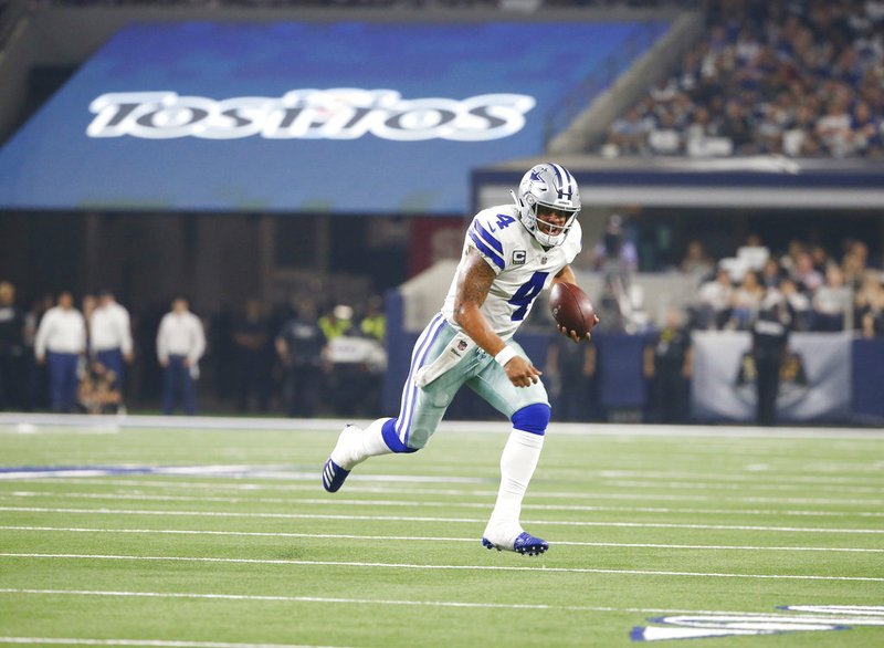 Dallas Cowboys quarterback Dak Prescott (4) carries the ball during the second half of an NFL football game against the New York Giants in Arlington, Texas, Sunday, Sept. 16, 2018. (AP Photo/Ron Jenkins)

