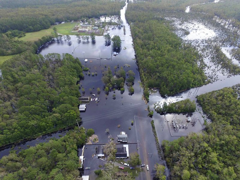 Homes and a power station are surrounded by floodwaters in the aftermath of Hurricane Florence in Newport, N.C., Monday, Sept. 17, 2018. (AP Photo/Tom Copeland)

