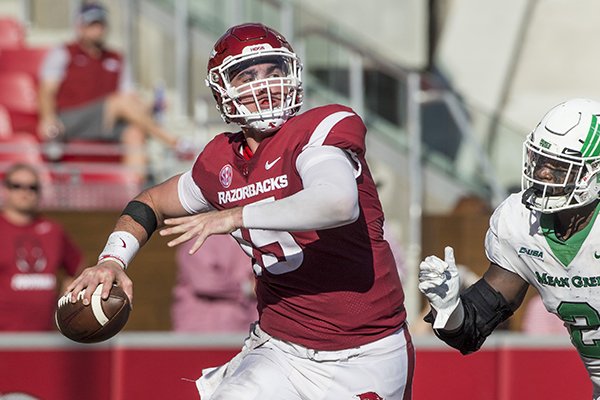 Cole Kelley, Arkansas quarterback, throws the ball before taking a hit from LaDarius Hamilton, North Texas defensive end, in the 2nd quarter Saturday, Sept. 15, 2018, at Razorback Stadium in Fayetteville.