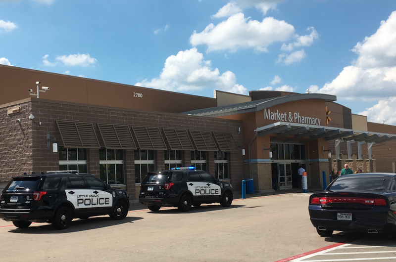 Police vehicles are seen outside a Walmart in west Little Rock, after a bank branch inside the store was robbed Monday.