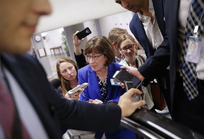 Sen. Susan Collins, R-Maine, speaks to reporters Monday as she walks to the Senate floor on Capitol Hill in Washington.