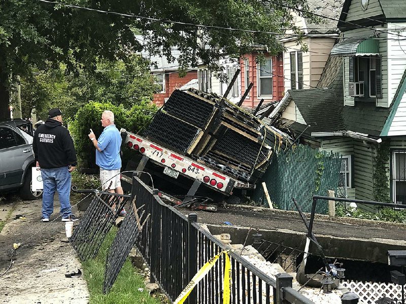 A tractor-trailer crashed into a home on South Avenue in Mariners Harbor, N.Y. on Monday. The Fire Department of New York says one civilian and one firefighter were treated for non-life-threatening injuries after the crash in the Mariners Ha bor neighborhood on Staten Island.
