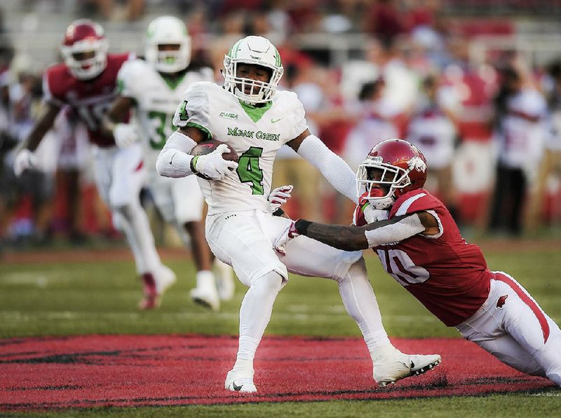 NWA Democrat-Gazette/CHARLIE KAIJO North Texas Mean Green safety Khairi Muhammad (4) intercepts a pass intended for an Arkansas Razorbacks receiver during the fourth quarter of a football game, Saturday, September 15, 2018 at Donald W. Reynolds Razorback Stadium in Fayetteville.

