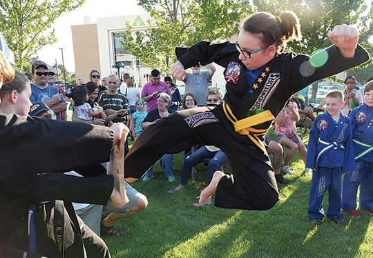 The Sentinel-Record/Grace Brown KARATE KID: Kayla Allen, 12, of Hot Springs, kicks a board Monday during the inaugural Halfway to St. Patrick's Day Pop Up Pub Party, held on the Hot Springs Convention Center lawn to celebrate that only six months remain until the annual parade on March 17.