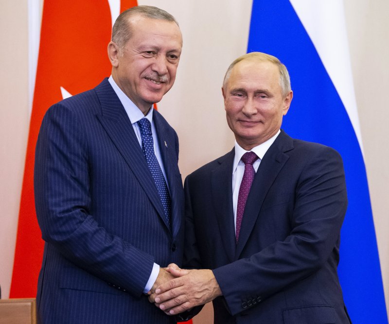 The Associated Press HAND SHAKE: Russian President Vladimir Putin, right, and Turkish President Recep Tayyip Erdogan shake hands after their joint news conference following the talks in the Bocharov Ruchei residence in the Black Sea resort of Sochi in Sochi, Russia, Monday. Turkish President Recep Tayyip Erdogan meets for the second time in 10 days with Russia's Vladimir Putin.