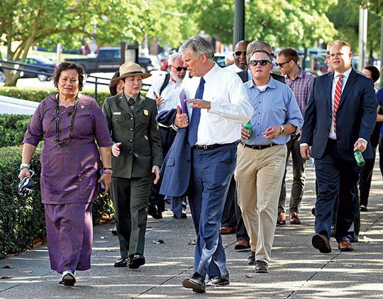 The Sentinel-Record/Grace Brown WALKING TOUR: From left, U.S. Rep. Amata Radewagen, R-American Samoa, and Hot Springs National Park Superintendent Laura Miller accompany Mayor Pat McCabe and others Monday as they get a firsthand look at how the National Park Service's historic leasing program has benefited Bathhouse Row. The tour followed a House Committee on Natural Resources oversight hearing at City Hall.