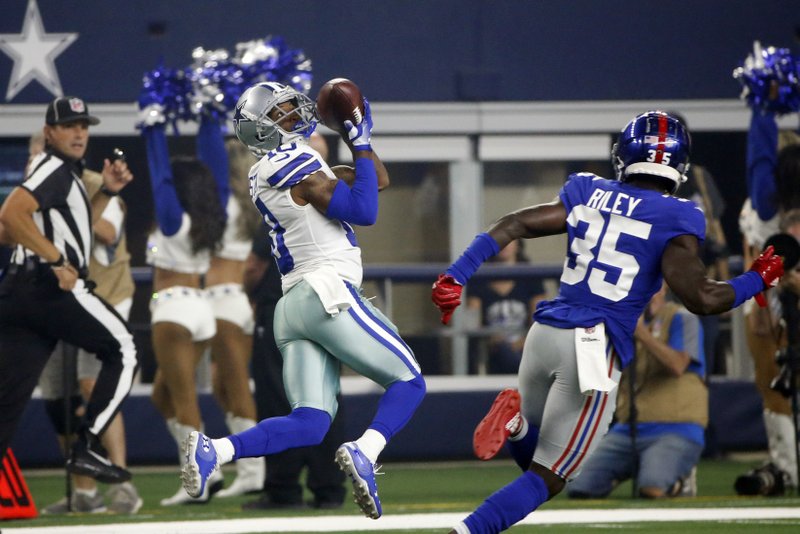 The Associated Press EARLY SCORE: Dallas Cowboys wide receiver Tavon Austin (10) pulls in a pass in front of New York Giants cornerback Curtis Riley (35) to score a 64-yard touchdown on the third play of Sunday's game in Arlington, Texas.