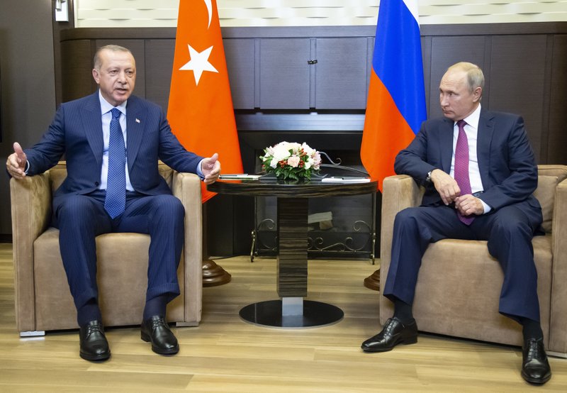 Turkish President Recep Tayyip Erdogan, left, gestures while speaking to Russian President Vladimir Putin, during their meeting in the Bocharov Ruchei residence in the Black Sea resort of Sochi in Sochi, Russia, Monday, Sept. 17, 2018. The presidents of Russia and Turkey are meeting in the Russian Black Sea resort of Sochi on Monday in a bid to find a diplomatic resolution to the crisis around a rebel-held region in Syria. (AP Photo/Alexander Zemlianichenko, Pool)