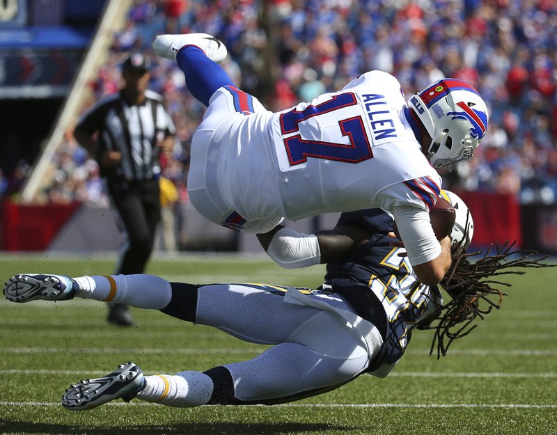 Buffalo Bills quarterback Josh Allen, top, is tacked by Los Angeles Chargers' Jahleel Addae during the second half of an NFL football game, Sunday, Sept. 16, 2018, in Orchard Park, N.Y. (AP Photo/Rich Barnes)