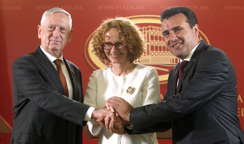 U.S. Defense Secretary James Mattis, left, Macedonian Prime Minister Zoran Zaev, right and Macedonian Defense Minister Radmila Sekerinska, center, shake hands while posing for the media, after their meeting at the government building in Skopje, Macedonia, Monday, Sept. 17, 2018. Mattis arrived in Macedonia Monday, condemning Russian efforts to use its money and influence to build opposition to an upcoming vote that could pave the way for the country to join NATO, a move Moscow opposes. (AP Photo/Boris Grdanoski)