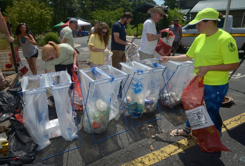 Volunteers sort recyclables Saturday, July 8, 2017, at the Hobbs State Park - Conservation Area visitor center after taking part in the annual Lake Appreciation Month Cleanup around Beaver Lake near Rogers. The park partnered with Beaver Watershed Alliance, the U.S. Army Corps of Engineers, Beaver Water District, Keep Arkansas Beautiful, The Northwest Arkansas Master Naturalists, Benton County agencies and corporate sponsors to coordinate the cleanup effort with volunteers in boats, on the shorelines and along roadways near Beaver Lake. 