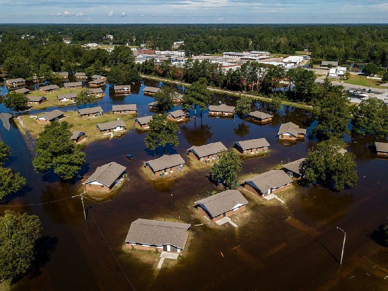 Water seeps into homes Tuesday in hard-hit Lumberton, N.C., but officials said the Lumber River appeared to finally be falling in the town about 70 miles inland. 