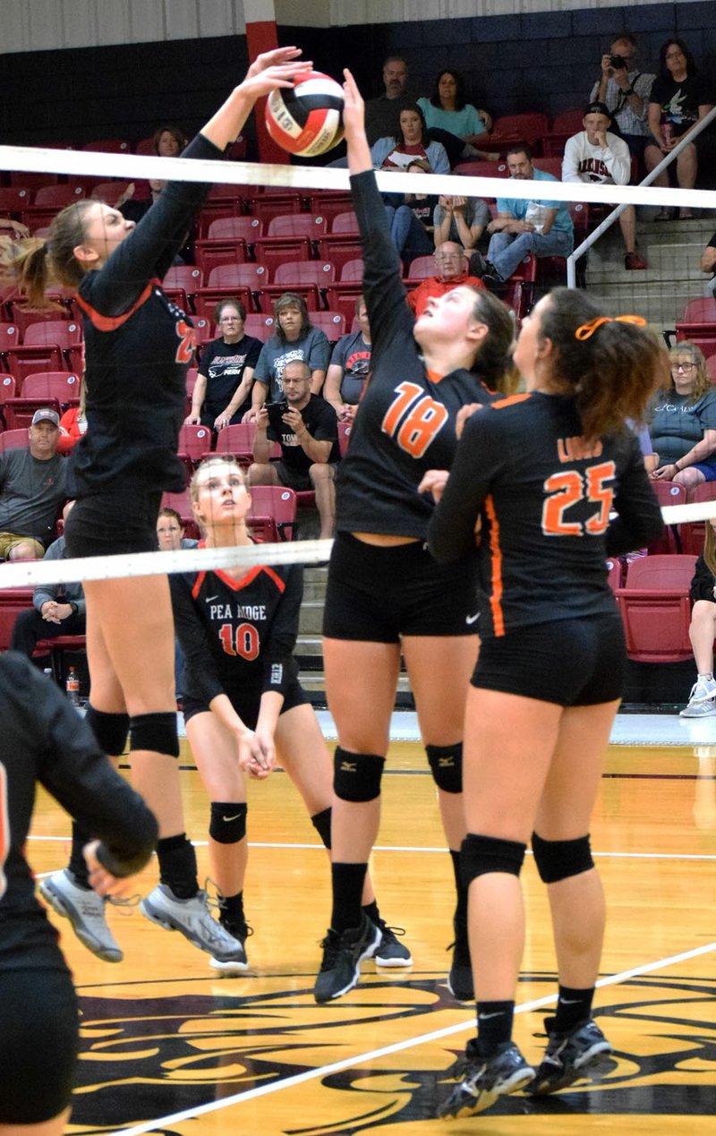 Westside Eagle Observer/MIKE ECKELS Kynley Burton (Pea Ridge 24, left) and Haley Dawson (Gravette 18) battle it out over the ball at the top of the net during the second set of the Pea Ridge-Gravette varsity volleyball match in the gym at Pea Ridge Sept. 13.