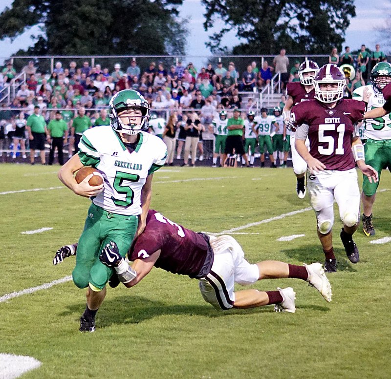 Westside Eagle Observer/RANDY MOLL Gentry senior Peyton Wright pulls down Greenland ball carrier Jett Dennis during the Friday night game in Gentry (on Sept. 14, 2018).