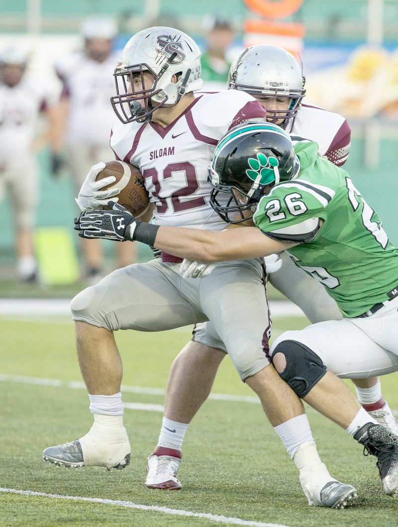 Ben Goff/NWA Democrat-Gazette Kaiden Thrailkill, Siloam Springs running back, fends off Van Buren defender Christian Carney during last Friday's game at Citizens Bank Stadium. Thrailkill rushed 36 times for 257 yards and two touchdowns in the Panthers' 35-32 victory over the Pointers.