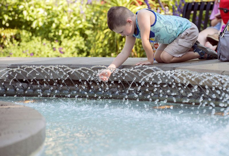 NWA Democrat-Gazette/J.T. WAMPLER Max Martin, 4, plays n the fountain on the Bentonville square Monday. Max was at the square with his sister Bryn, 2, and has mom, Jenna Martin of Bella Vista. The National Weather Service is calling for sunny weather this week with no rain likely.
