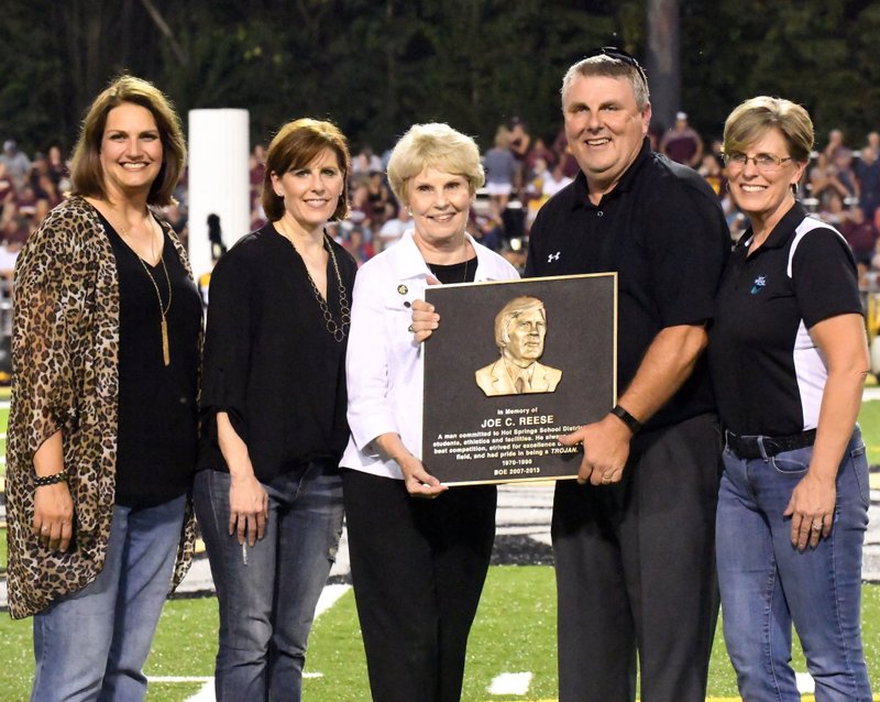 The Sentinel-Record/Grace Brown FAMILY AFFAIR: The family of former Hot Springs coach Joe Reese accepts a plaque on his behalf during halftime of Hot Springs football game against Lake Hamilton on Friday. Pictured, from left, are his daughter-in-law Sara Reese, daughter Angie Venable, widow Karen Reese, son Brad Reese and daughter Leigh Cobb.